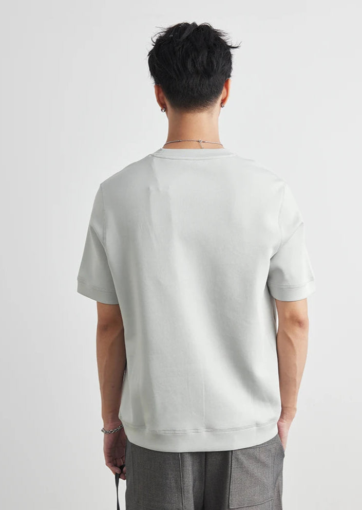 CIIVET - Model wearing a plain white t-shirt on a light grey background