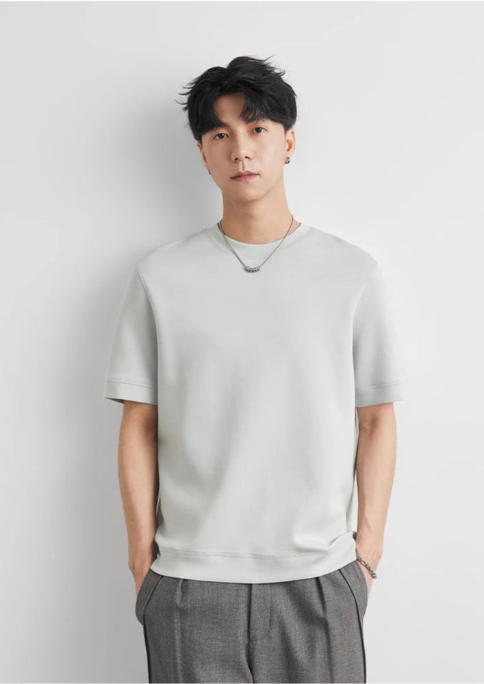 CIIVET - Model wearing a light grey O-neck sweater and grey pants against a white background