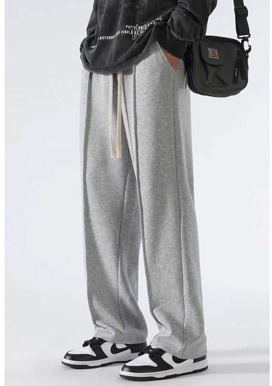 CIIVET - Model wearing gray sweatpants with a black bag on a white background