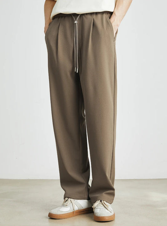 CIIVET - Model wearing brown pants with a white background