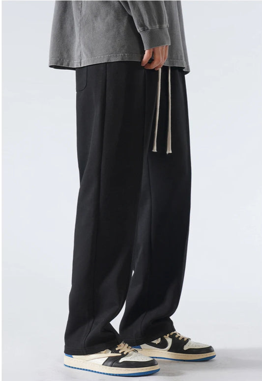 CIIVET - Model wearing black wide-leg pants with a plain background